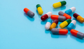 Antibiotic capsule pills on blue background. Prescription drugs. Colorful capsule pills. Antibiotic - PhotoDune Item for Sale