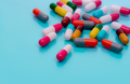 Antibiotic capsule pills on blue background. Prescription drugs. Colorful capsule pills. Antibiotic - PhotoDune Item for Sale