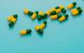 Green-yellow capsules spread on blue background. Tramadol capsule pills for relieve severe cancer - PhotoDune Item for Sale