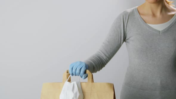Woman with Shopping Bag, Face Mask and Gloves