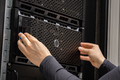 Close-up of hands Of IT Consultant Installing Servers In Datacenter - PhotoDune Item for Sale