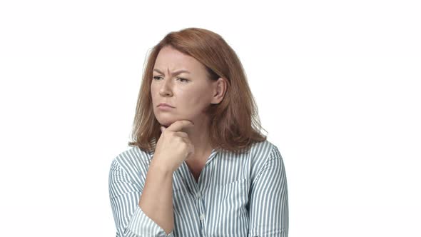 Focused and Thoughtful Redhead Adult Woman Have Hard Choice Touching Neck As Thinking Frowning Look