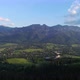 Aerial view of green hills in summer. Giewont massif in the Tatra Mountains and view of Zakopane.  - VideoHive Item for Sale