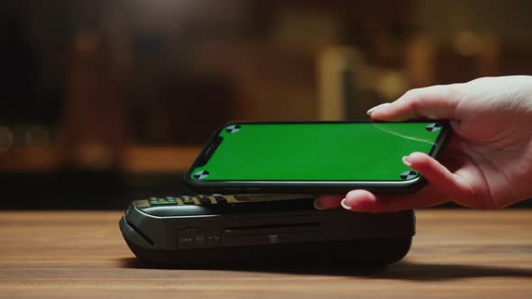 Paying By Smartphone with Chroma Green Screen Closeup