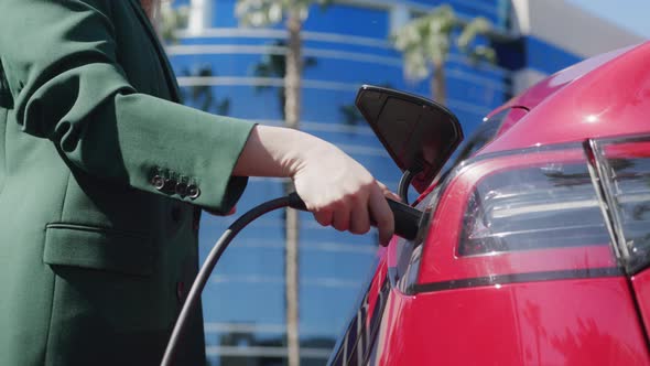 Closeup Slow Motion Woman Opening Zero Emission Electric Vehicle for Charging