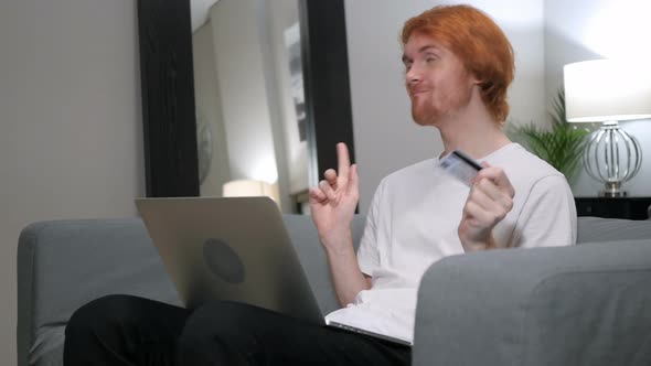 Redhead Man Excited for Successful Online Shopping