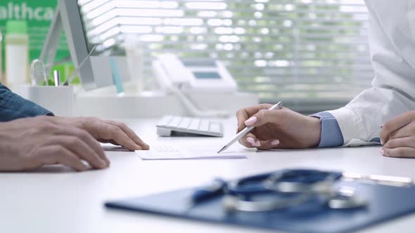 Doctor giving a prescription to a patient