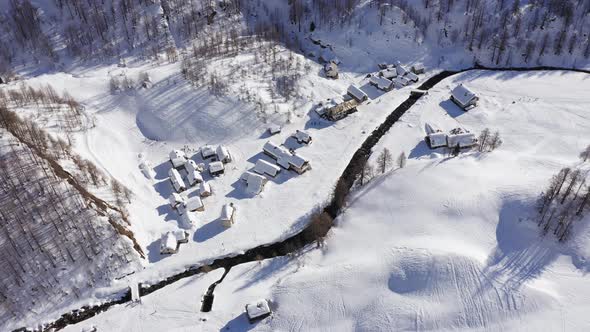 Aerial Over Winter Wonderland, Snowy Village in Sunny Winter day.Winterland Scene with Lodges