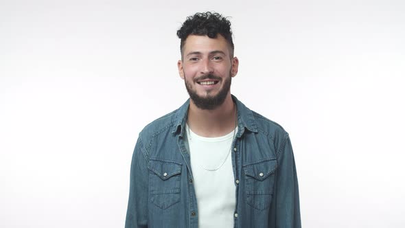 Slow Motion Portrait Bearded Caucasian Guy Look Friendly and Amused Camera Raise Eyebrows Astonished