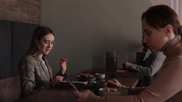 Young Women in a Sushi Restaurant