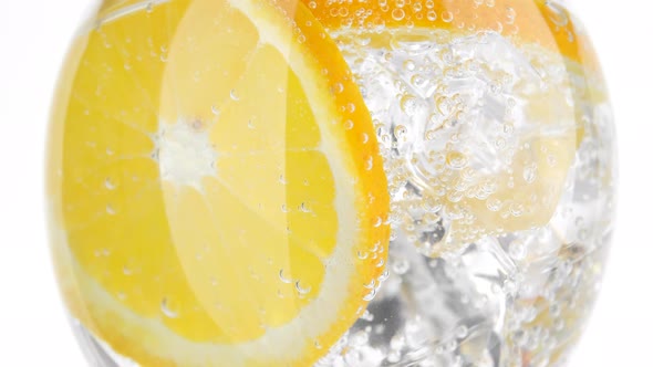 Refreshing water. drink with orange, sparkling water and ice, closeup