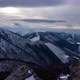 Turbulent Clouds Undulate Over the Tops of the Hills in Winter Spruce Stands From Behind the Rocks - VideoHive Item for Sale