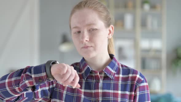 Young Woman Waiting While Checking Time