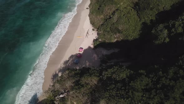 Aerial View of Tropical Beach with Azure Blue Water and Foaming Ocean Waves