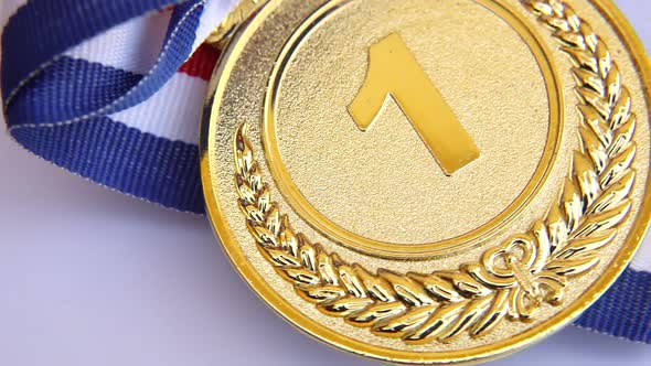 Top View of Winner or Champion Gold Trophy Medal Rotating on White Background