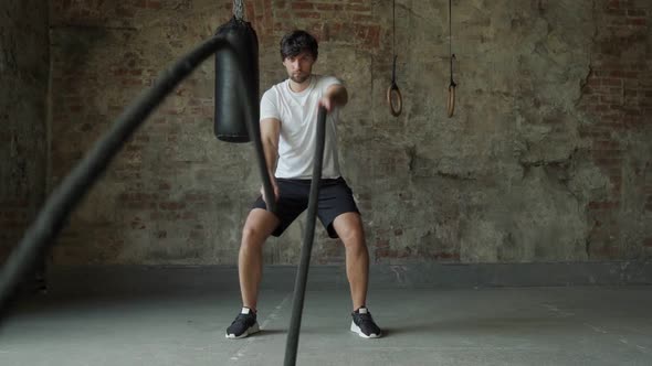 Powerful Man Training with Rope in Functional Training Fitness Gym