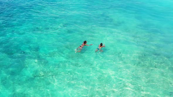 Tourists tanning on tropical sea view beach voyage by blue sea and white sandy background of Bali ne