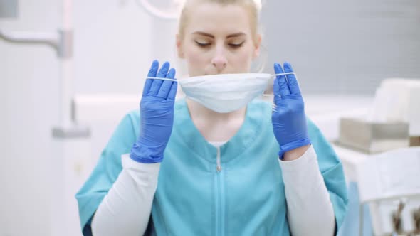 Dentist Putting on Protective Mask Before Surgery