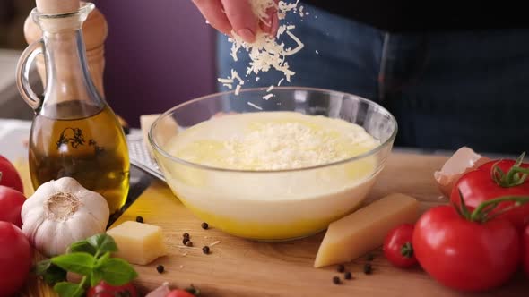 Making Pasta Carbonara  Pouring Grated Parmesan Cheese Into Glass Bowl