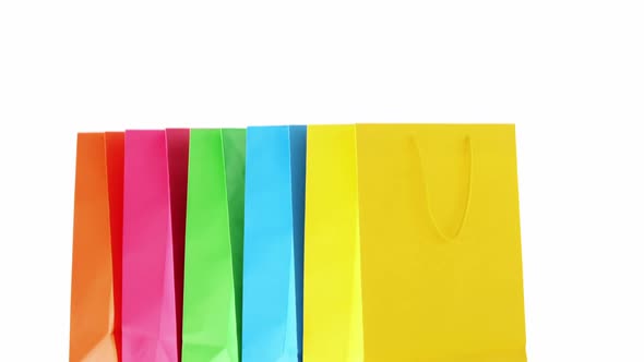 Multicolored shopping bags on white background