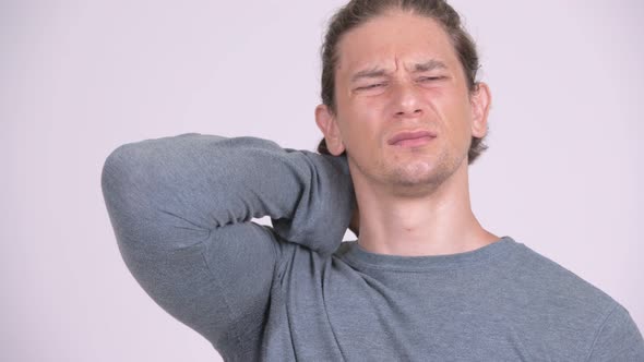 Face of Stressed Man Having Neck Pain Against White Background