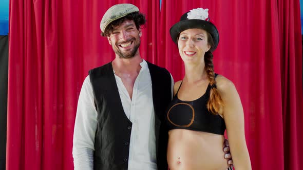 Happy artist couple laughing in circus tent