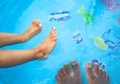 close up of diverse feet in pool water - PhotoDune Item for Sale