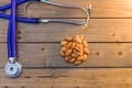 Doctors stethoscope on wood with almonds room for print light leak on right side - PhotoDune Item for Sale