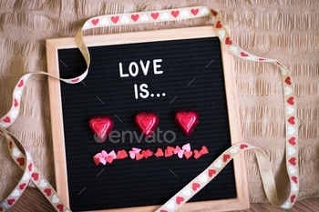 "Love is" text on a letterboard