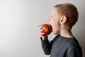 Child eating red apple with I Love You - PhotoDune Item for Sale