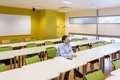 Woman in face mask in empty classroom - PhotoDune Item for Sale