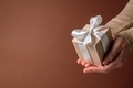 Beige gift box in hands - PhotoDune Item for Sale