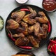 Grilled Chicken Wings with Chilli Pepper on a Rustic Plate Served with Various Dips and Bread - VideoHive Item for Sale