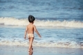 Little boy walking down the beach to feel the waves  - PhotoDune Item for Sale