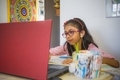 Little girl using technology for online studies. - PhotoDune Item for Sale