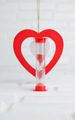 red hourglass and decorative red heart stand on white background - PhotoDune Item for Sale