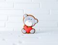 gingerbread in the form of a teddy bear with a heart on a red background - PhotoDune Item for Sale