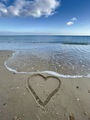 a heart drawn on the sand on the coast of the sea in sunny winter weather - PhotoDune Item for Sale