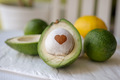 green healthy foods half an avocado with a pit and a drawn heart on it - PhotoDune Item for Sale