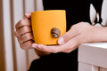 bright yellow cup in the hands of a teenager - PhotoDune Item for Sale