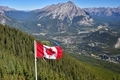 Canada flag with Canadian rocky mountain at the background - PhotoDune Item for Sale
