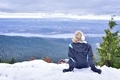 Girl enjoying the beauty of nature from mountain top sitting on snow - PhotoDune Item for Sale