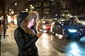 Woman using her phone standing beside a busy street  - PhotoDune Item for Sale