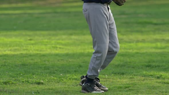 A young man playing catch with a baseball.