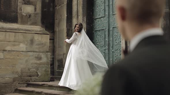 Newlyweds Caucasian Groom with Bride Walking Embracing Hugs on the City Street Wedding Couple