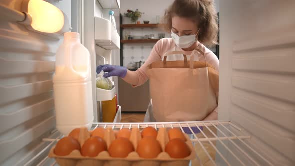 Woman Unpacks Online Home Food Delivery Putting in Fridge