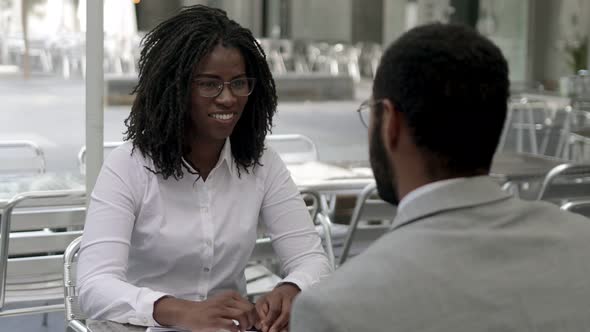 Smiling African American Woman Shaking Hands with Colleague