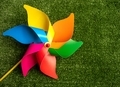 Colorful pinwheel toy on green grass background. - PhotoDune Item for Sale