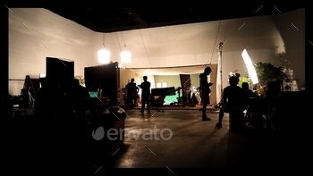 Silhoutte images of video production and lighting set for filming which movie crew team working and 
