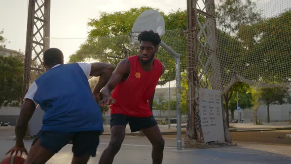 Cinematic footage of a street basketball game outdoor.